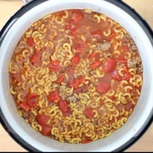 adding beef stock tomatoes and elbow macaroni