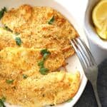 tilapia with lemon wedge and tartar sauce