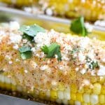 Mexican street corn with sauce, cojita cheese, cilantro