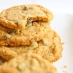 Pumpkin cookies stacked with a bite taken from one on top