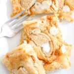 Pumpkin blondies with Oreo cookie chunks and a fork on a plate