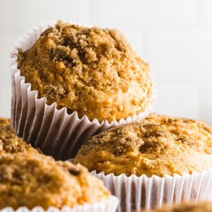 sweet potato muffins with cinnamon sugar stacked on top of one another