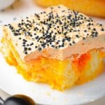 orange poke cake with black sprinkles