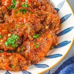 sweet thai sticky wings in a bowl with garnish