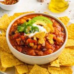 vegetarian smoky chili with tortilla chips, sour cream and avocado toppings