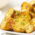 roasted Yukon Gold potatoes on a platter with parsley sprinkled on top