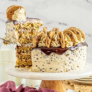 a slice of chocolate chip cookie cake being raised by a spatula