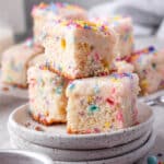 stack of three pieces of funfetti cake with sprinkles on the table