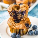 banana blueberry muffins stacked on top of each other on a white plate