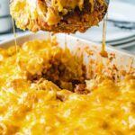 spatula lifting up a helping of cheesy sloppy joe tater tot casserole