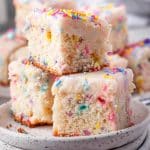 three pieces of funfetti cake with sprinkles stacked on top of one another