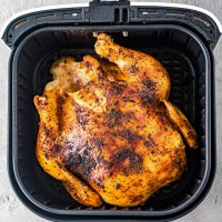 whole chicken in an air fryer basket