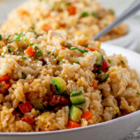 chicken fried rice and vegetables in a bowl