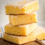 stack of four lemon brownies on a cutting board