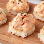 salmon sushi bites on a bamboo board